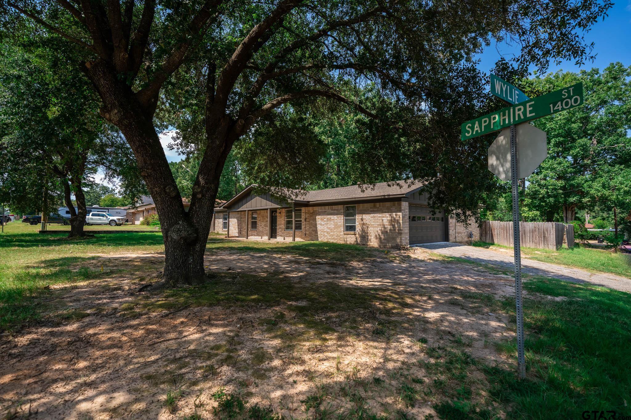 1411 Sapphire Street Longview, TX 75602 - Photo 8 of 38 a view of a house with a yard