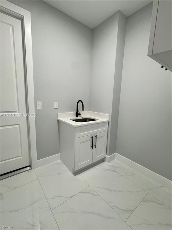 3414 4th Street Southwest Lehigh Acres, FL 33976 - Photo 14 of 28 a bathroom with a sink a toilet and a mirror