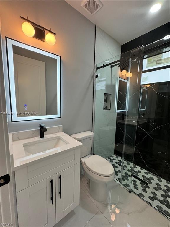 3414 4th Street Southwest Lehigh Acres, FL 33976 - Photo 22 of 28 a bathroom with a sink toilet and shower