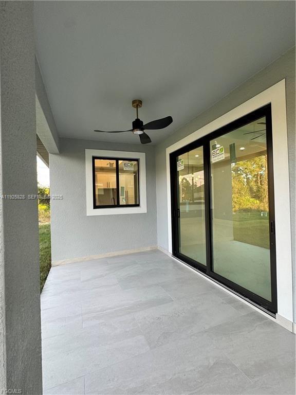 3414 4th Street Southwest Lehigh Acres, FL 33976 - Photo 24 of 28 a view of an empty room with a window and a kitchen