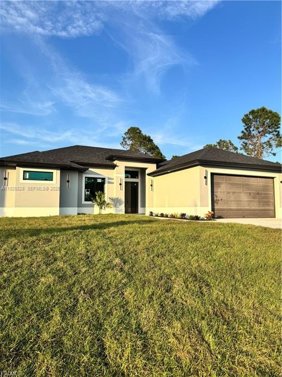 3414 4th Street Southwest Lehigh Acres, FL 33976 - Photo 3 of 28 a front view of a house with a garden