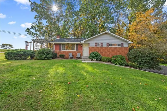 a front view of house with yard and green space
