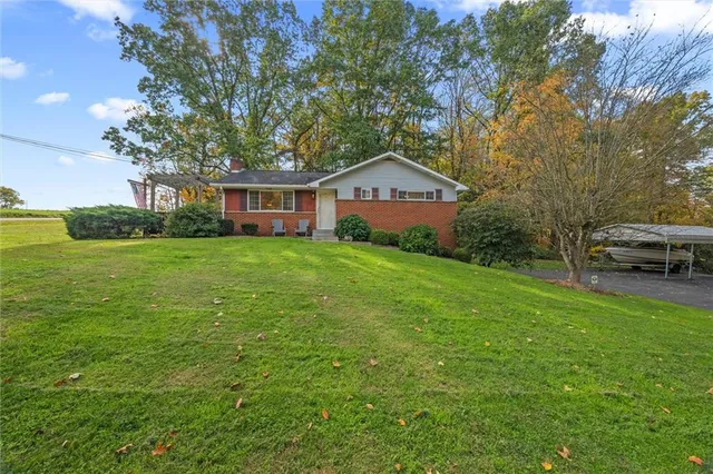 a view of a house with a yard porch and sitting area