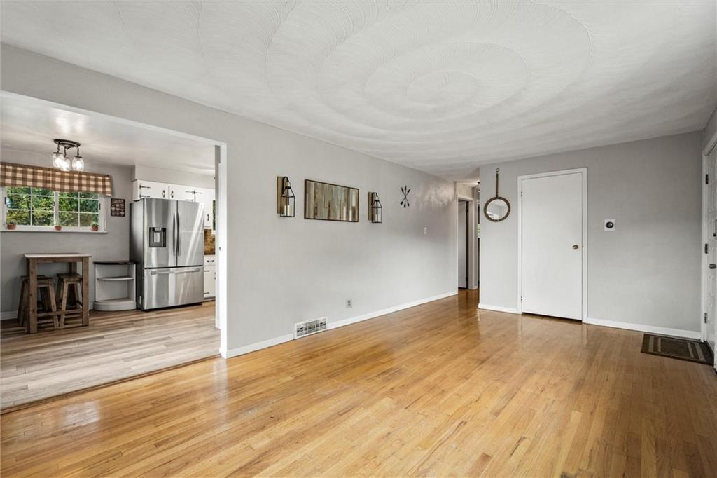 130 Hidden Hill Road Sarver, PA 16055 - Photo 4 of 36 an empty room with wooden floor and windows