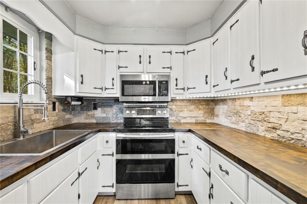130 Hidden Hill Road Sarver, PA 16055 - Photo 5 of 36 a kitchen with stainless steel appliances granite countertop a sink and a stove
