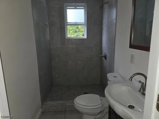 a bathroom with a toilet sink and shower