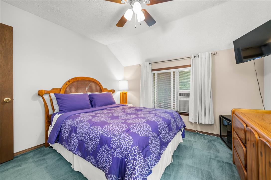 222 Powder Horn Road Henryville, PA 18332 - Photo 12 of 25 A well-lit bedroom featuring a sloped ceiling and comfortable carpeting, ideal for serene relaxation.