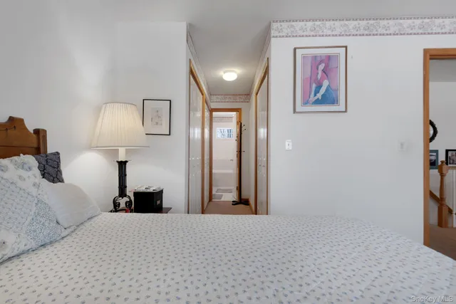 a bedroom with a bed and a lamp