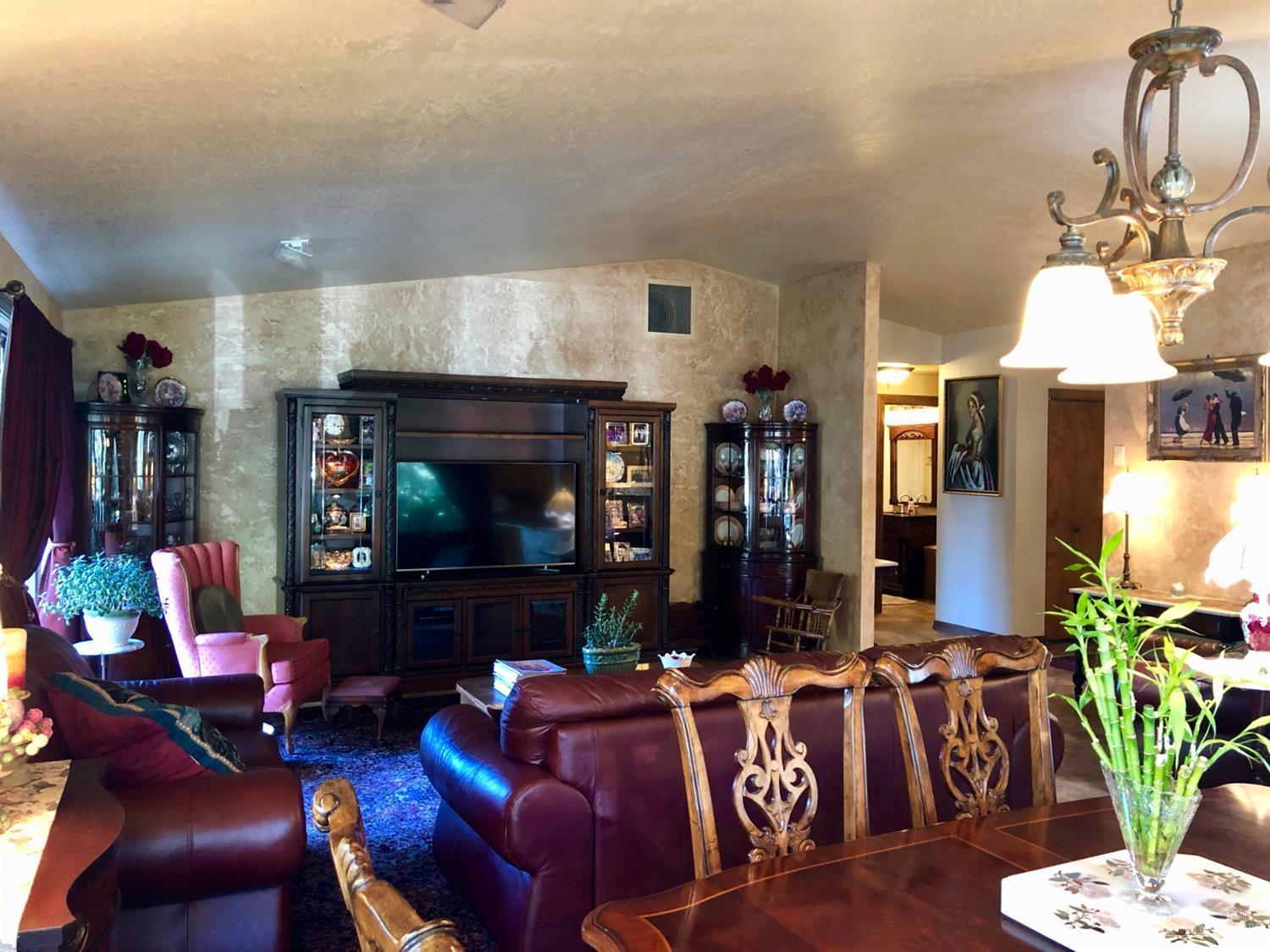 20416 Bullblock Road Bend, OR 97702 - Photo 10 of 23 a living room with furniture a flat screen tv and a fireplace