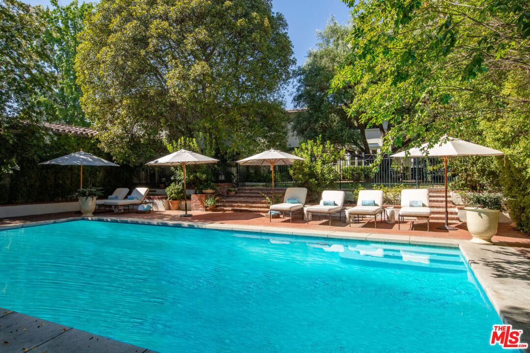 1640 Lombardy Road Pasadena, CA 91106 - Photo 17 of 39 a table and chairs under an umbrella in backyard
