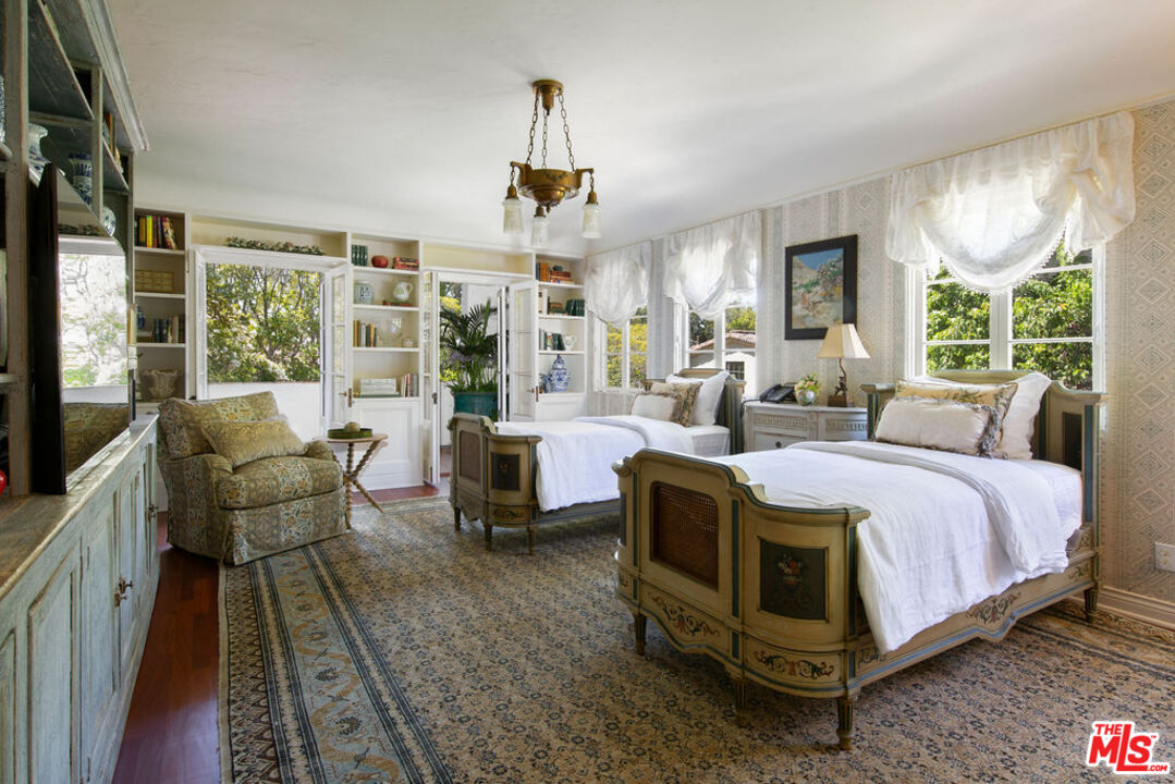 1640 Lombardy Road Pasadena, CA 91106 - Photo 22 of 39 a spacious bedroom with a bed a table and large windows