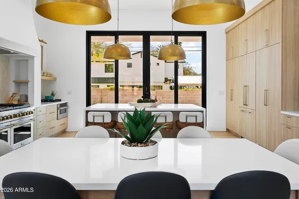 a view of a dining room with furniture and chandelier