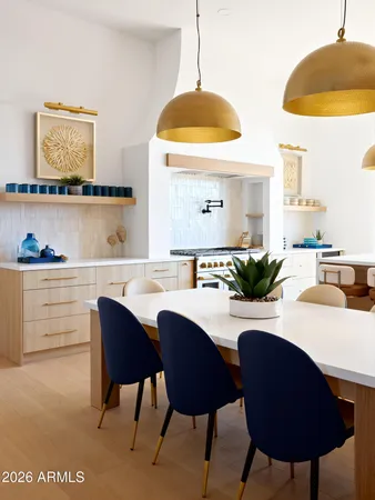 a dining room with furniture and a chandelier