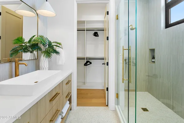 a bedroom with a bed and glass door
