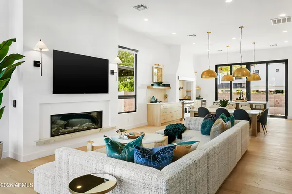 a living room with furniture fireplace and a flat screen tv