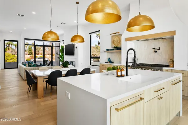a large kitchen with a table and chairs