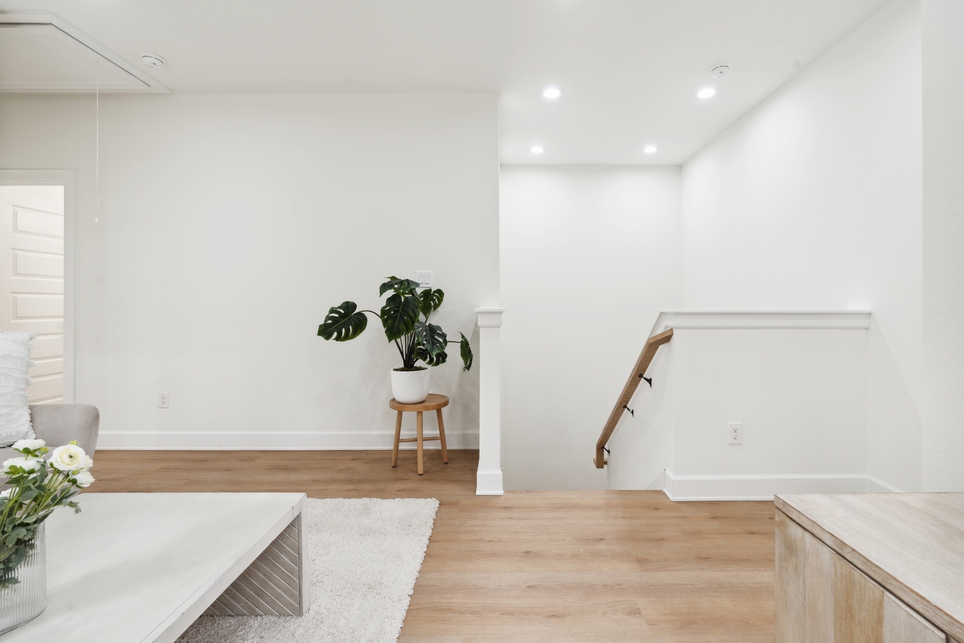 6408 Foster Street Houston, TX 77021 - Photo 14 of 39 Stair landing perspective — wood handrail detailing, warm oak-look steps, white risers, and an open entryway to the second-floor living quarters.