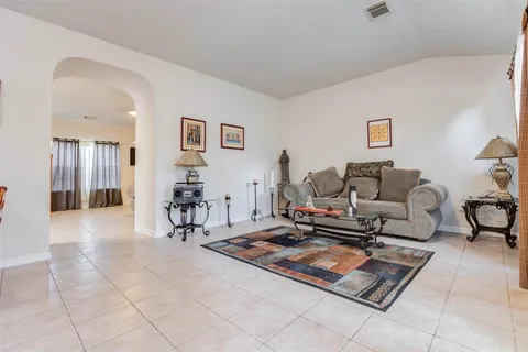 a living room with furniture a computer and a table