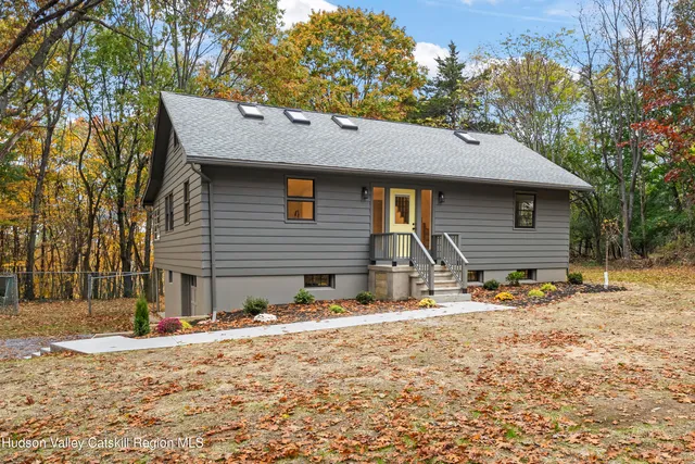 a backyard of a house with oven and trees