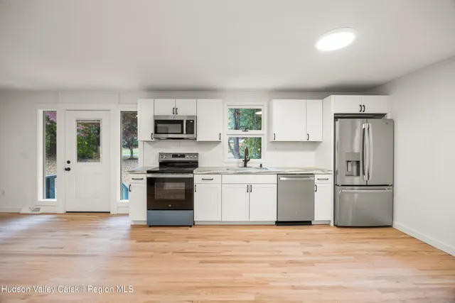 a kitchen with a refrigerator stove and microwave
