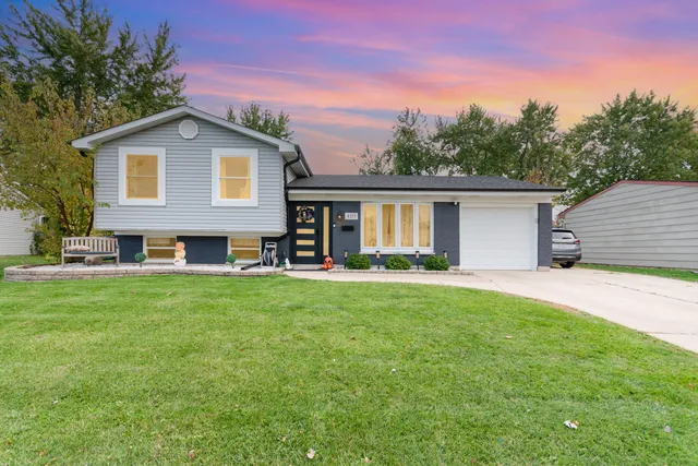 a view of a house with a backyard and patio
