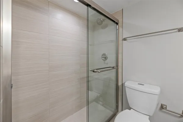 a bathroom with a toilet and shower