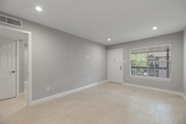 a view of an empty room with a window