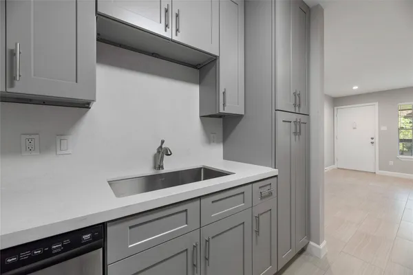 a kitchen with a sink and cabinets