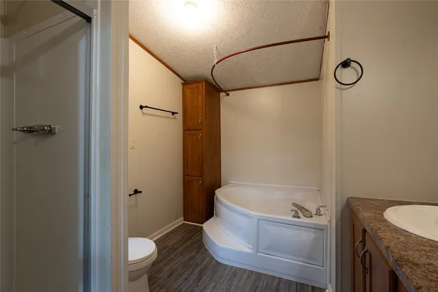 a bathroom with a tub toilet and shower