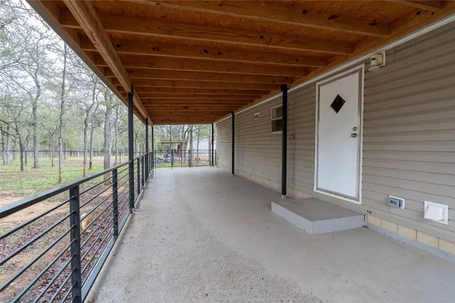 a view of a porch with wooden floor