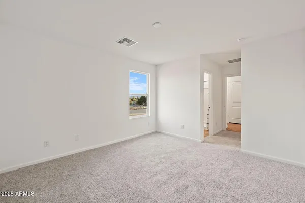 a view of an empty room and a window