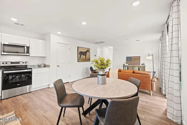 a kitchen with a table and chairs in it