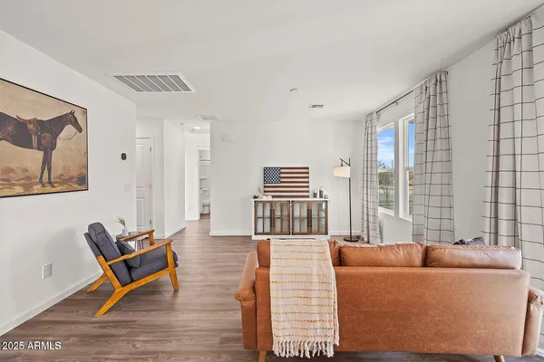 a living room with furniture and wooden floor