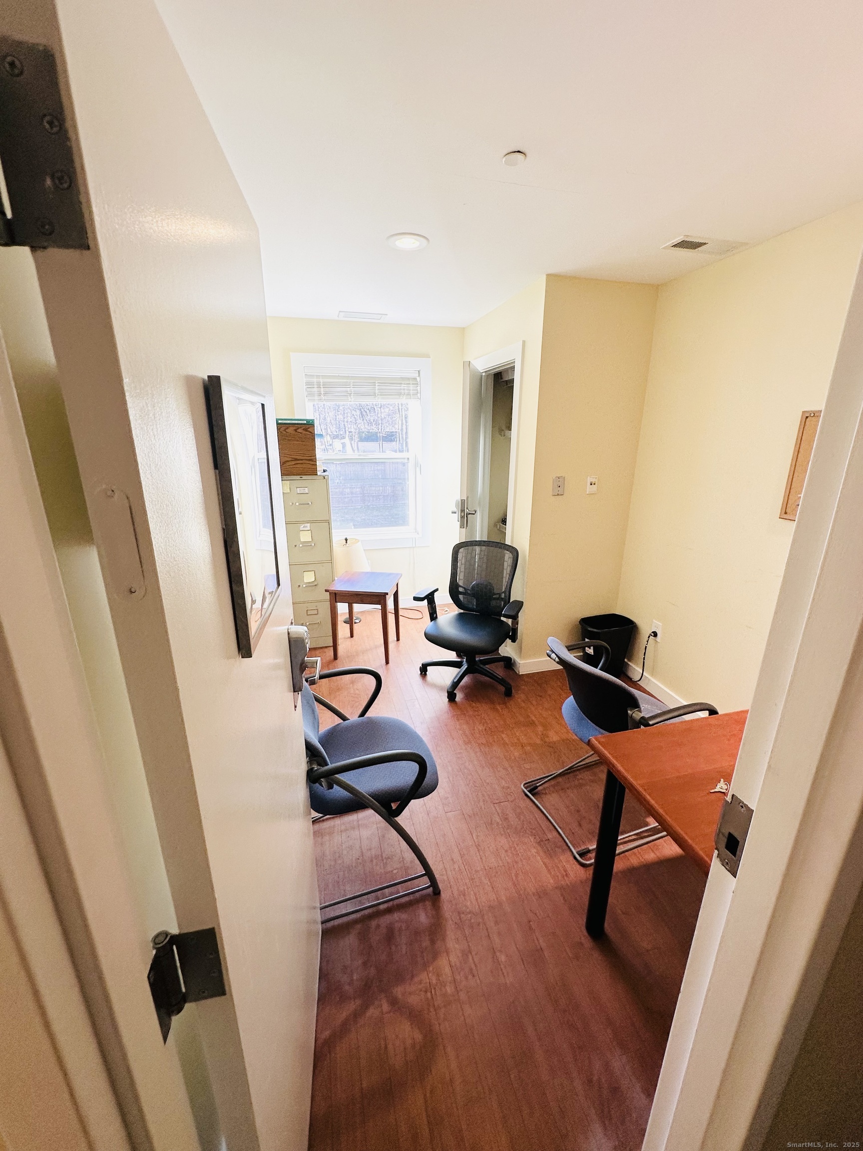 141 Valley Street New Haven, CT 06515 - Photo 12 of 30 a view of a workspace with furniture and a window