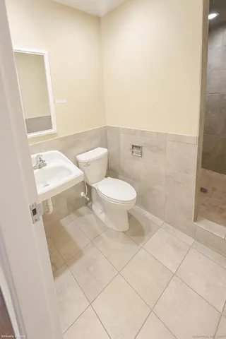 a bathroom with a toilet and a shower