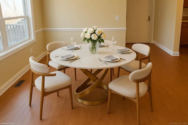 a view of a dining room with furniture and wooden floor