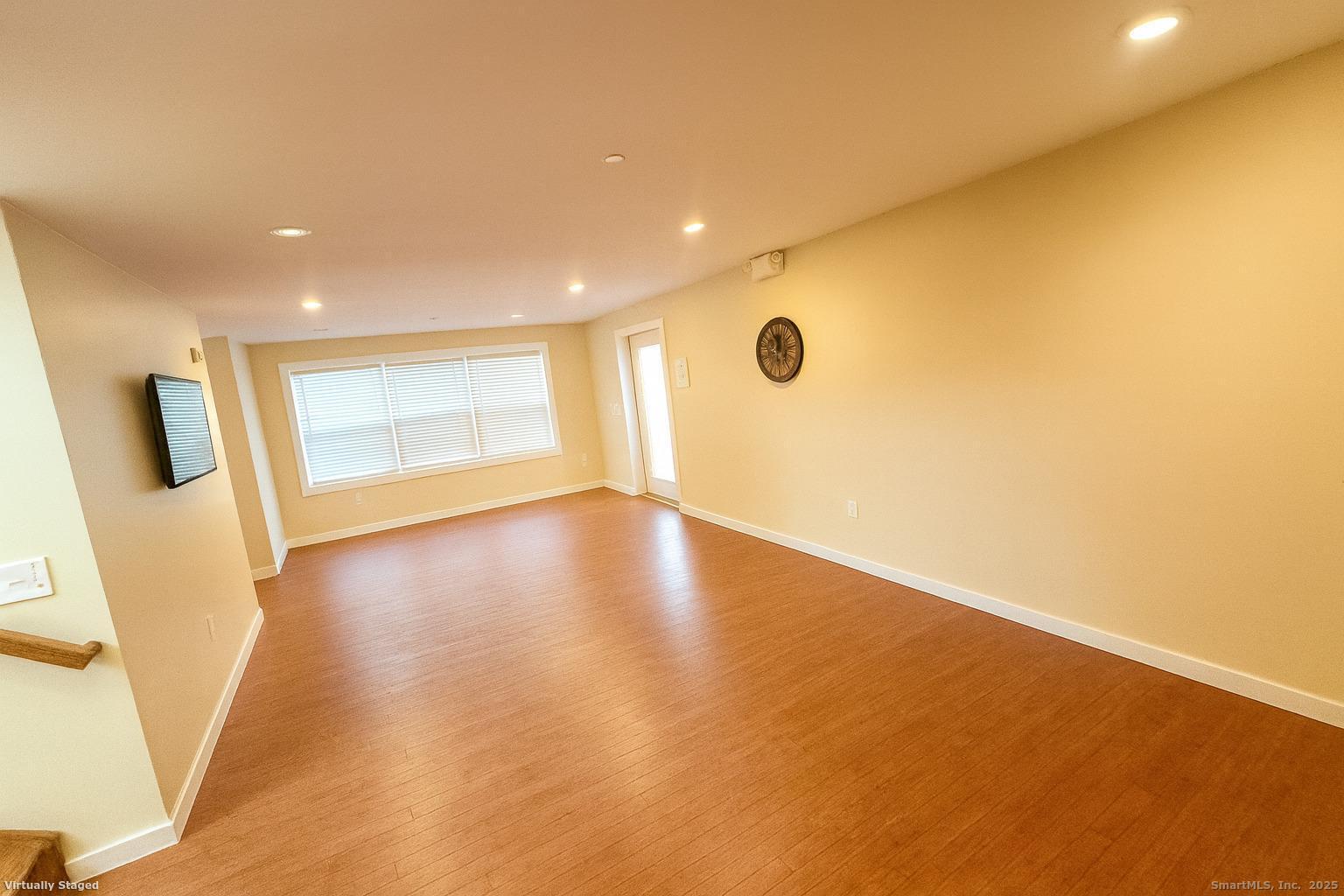 141 Valley Street New Haven, CT 06515 - Photo 7 of 30 a view of an empty room with wooden floor and a window