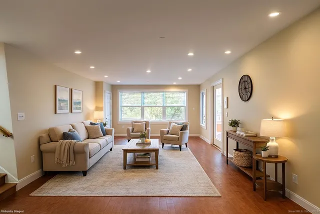 a living room with furniture rug and window