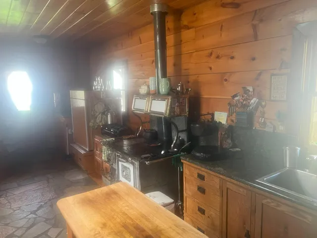 a living room with a large window and furniture