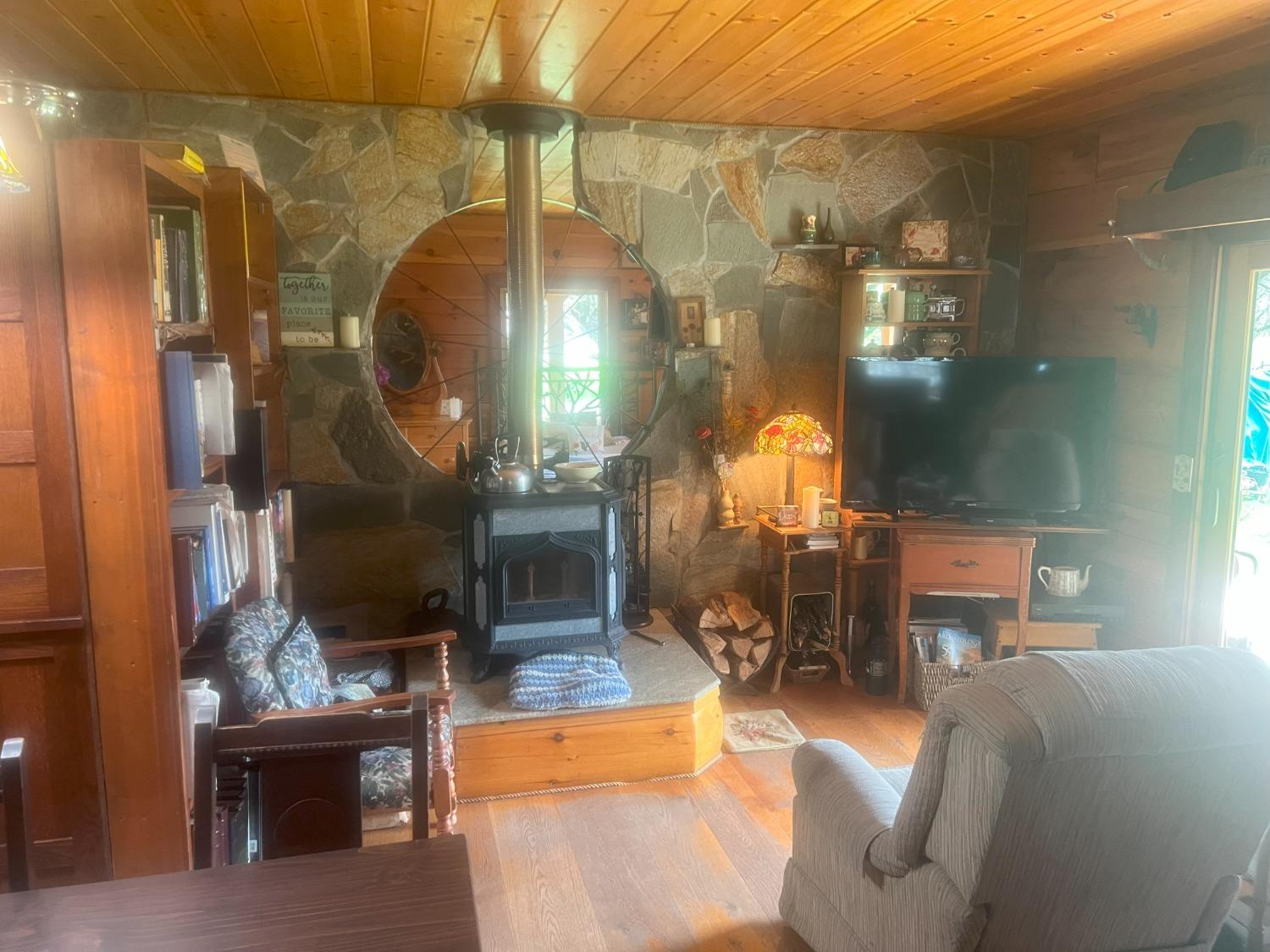 140040 Vincent Fire Road Tollhouse, CA 93667 - Photo 24 of 30 a living room with furniture a lamp and a fireplace