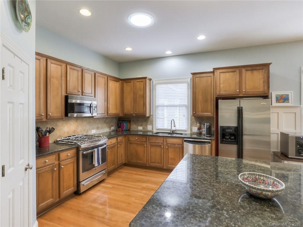 899 Stratford Run Drive Fort Mill, SC 29708 - Photo 12 of 48 a kitchen with stainless steel appliances granite countertop a sink stove and refrigerator