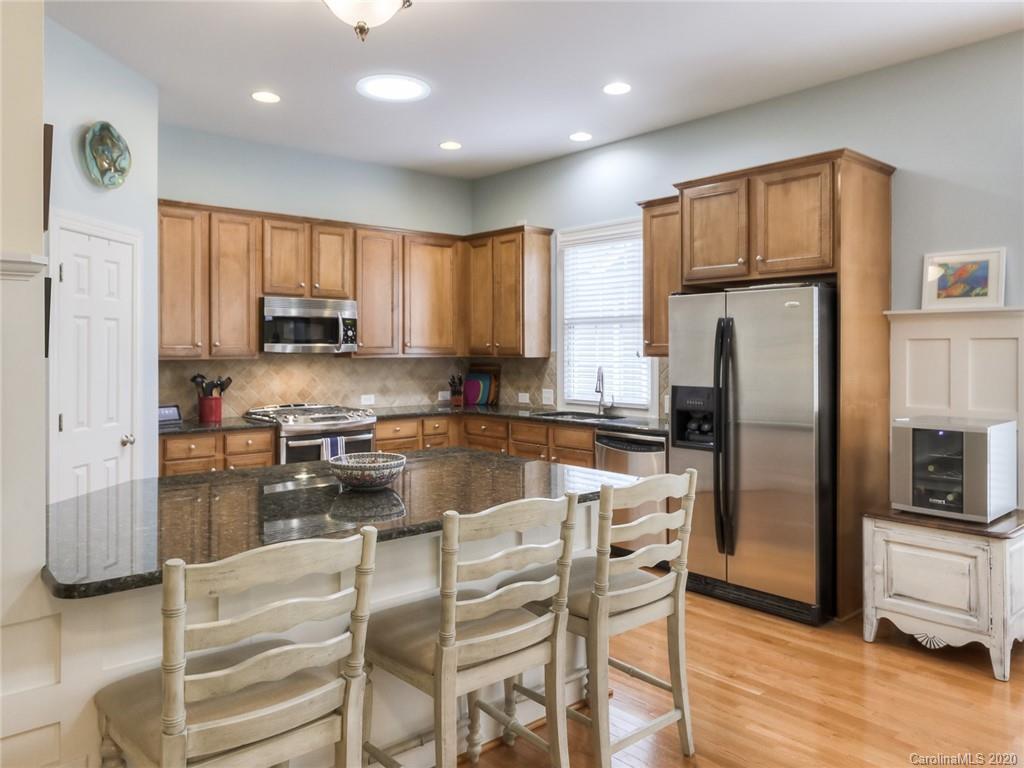 899 Stratford Run Drive Fort Mill, SC 29708 - Photo 13 of 48 a kitchen with kitchen island granite countertop a refrigerator stove microwave and sink