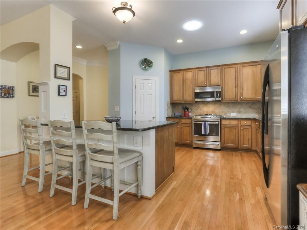 899 Stratford Run Drive Fort Mill, SC 29708 - Photo 14 of 48 a kitchen with stainless steel appliances a stove top oven and a refrigerator