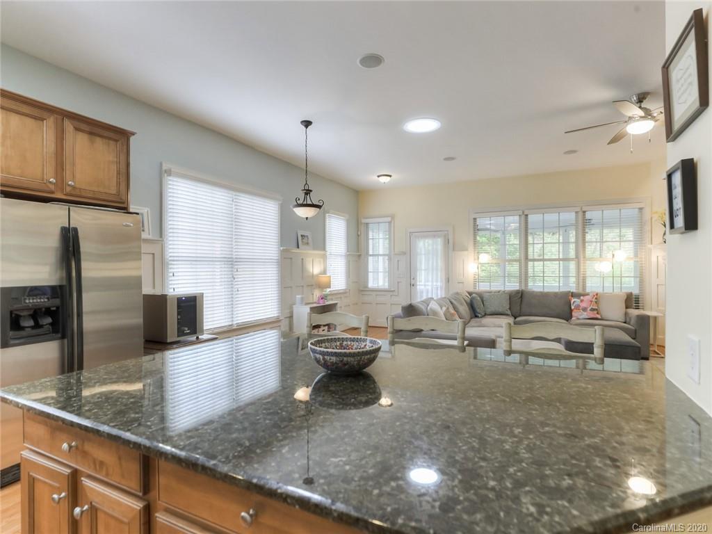 899 Stratford Run Drive Fort Mill, SC 29708 - Photo 15 of 48 a living room with granite countertop couches a fireplace with wooden floor