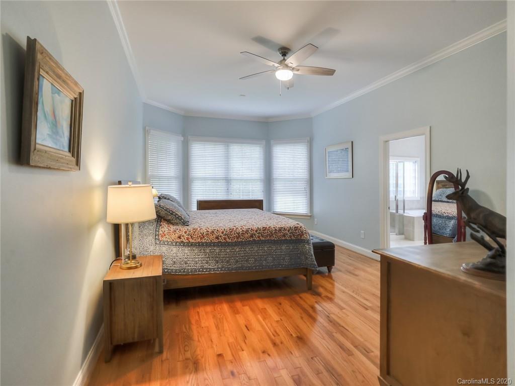 899 Stratford Run Drive Fort Mill, SC 29708 - Photo 24 of 48 a bedroom with a bed and a chandelier
