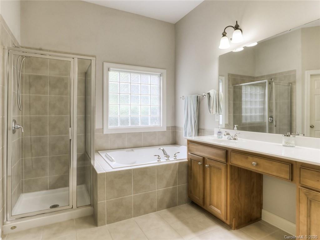899 Stratford Run Drive Fort Mill, SC 29708 - Photo 27 of 48 a bathroom with a tub sink shower and mirror