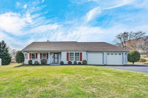 a front view of house with yard and green space