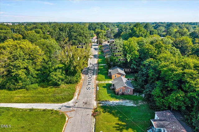 an aerial view of a house with a yard and outdoor seating