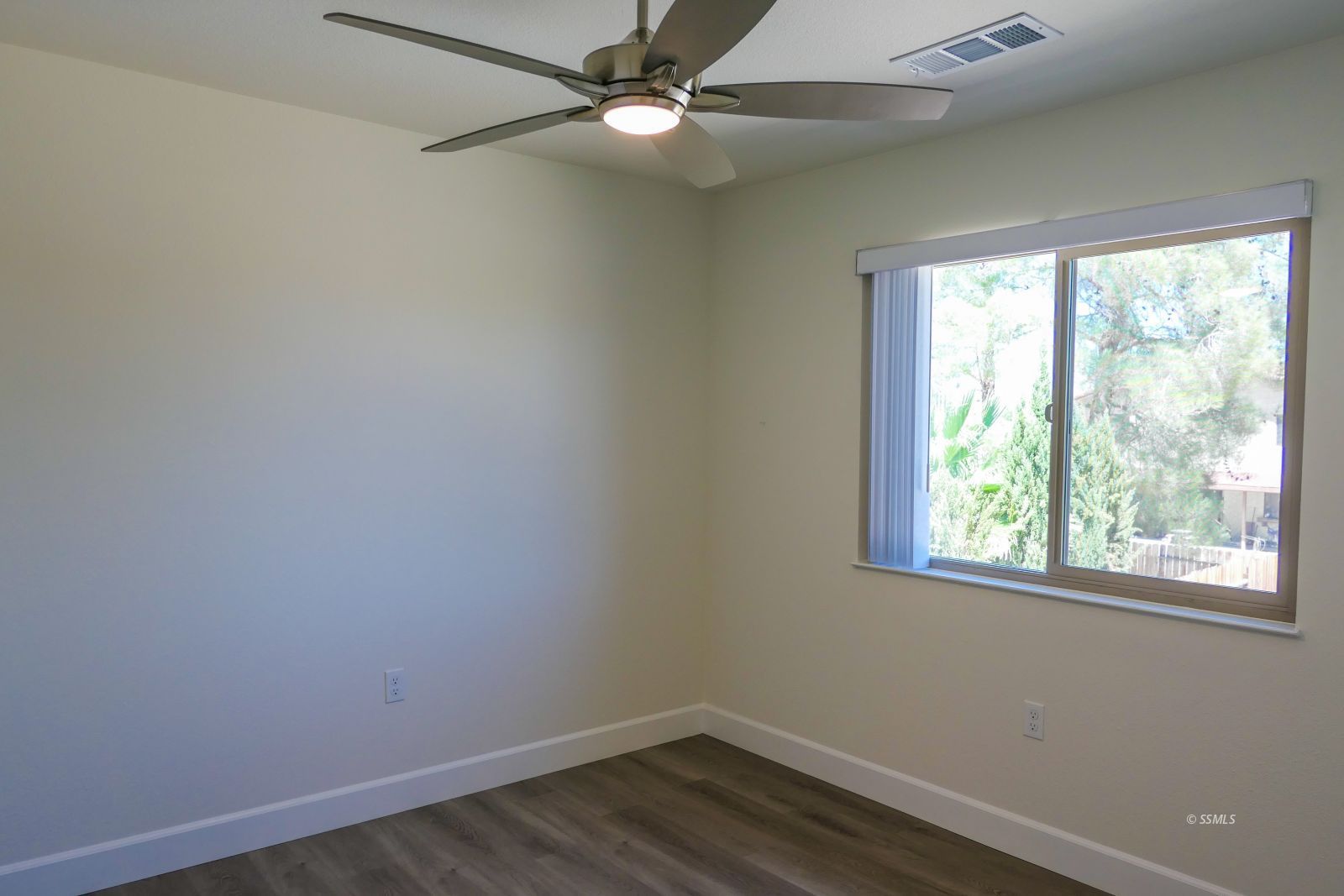 736 West Howell Avenue Ridgecrest, CA 93555 - Photo 37 of 50 an empty room with a window and wooden floor