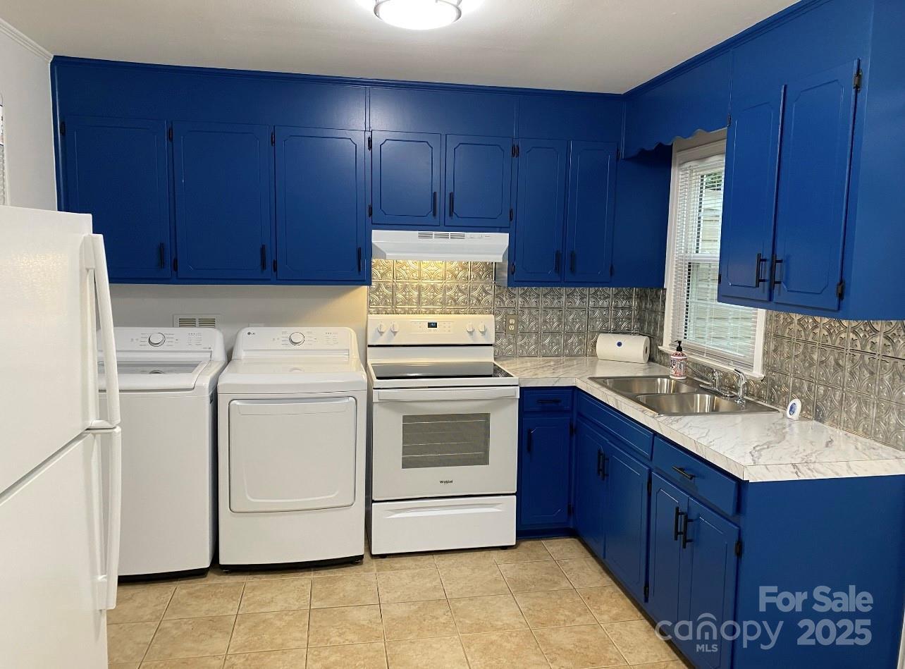 4100 Howie Circle Charlotte, NC 28205 - Photo 4 of 8 a kitchen with a stove sink and cabinets